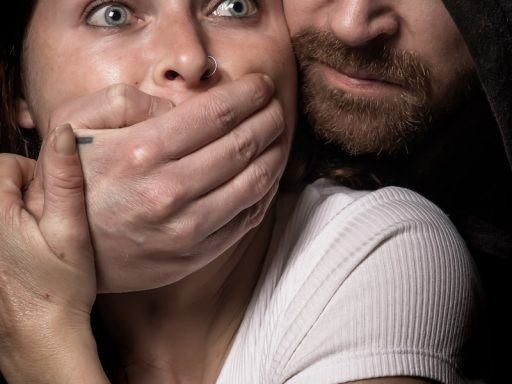 man apprehending woman in white tank top