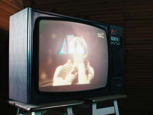 a television sitting on top of a step ladder