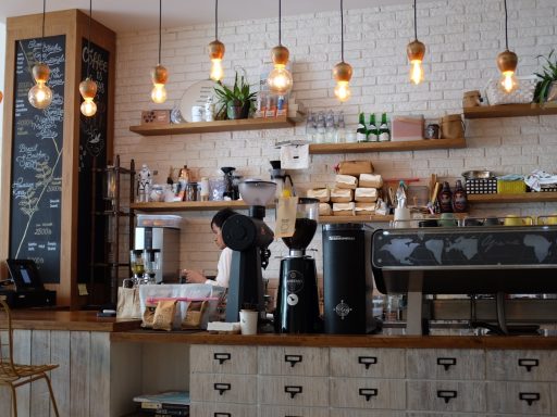 black kitchen appliance on kitchen island with pendant lights