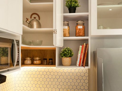 Stylish kitchen interior with open shelves, plants, and utensils.