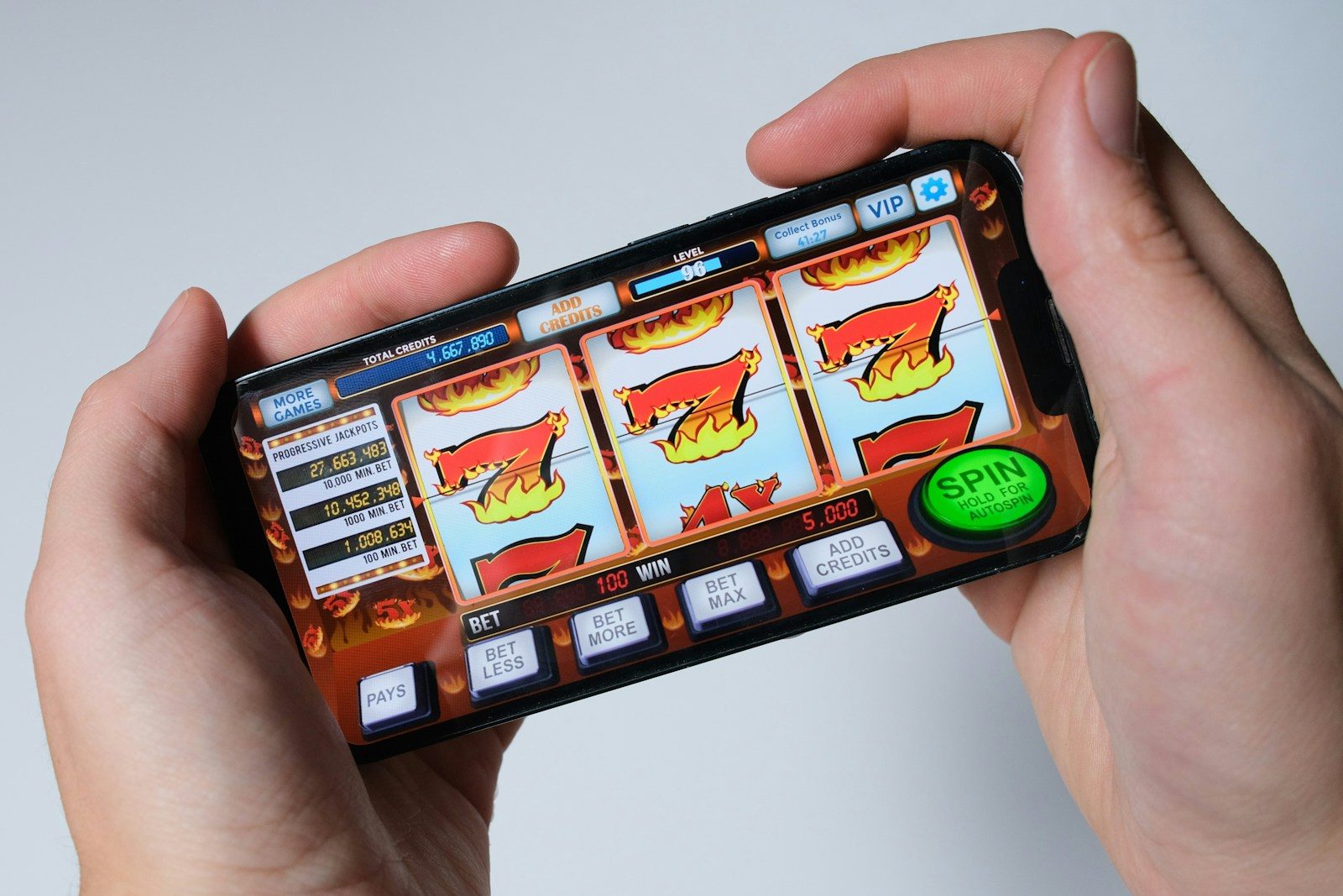 Someone is playing a mobile slot machine game.