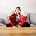 Persoon die reflectievragen opschrijft in een notitieboek aan een houten tafel