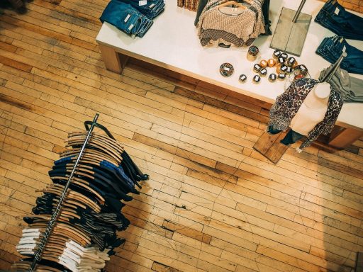Een rek met kleding in een duurzame kledingwinkel, symbool voor slow fashion