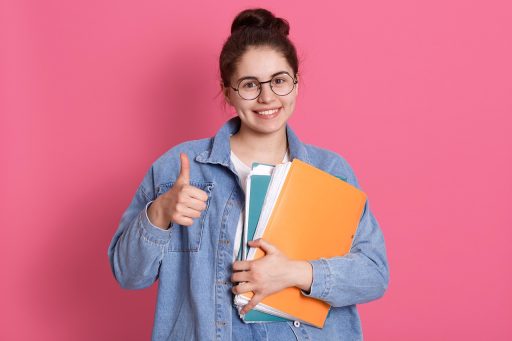 Volwassen student die studieboeken over voeding en diëtetiek bestudeert aan een bureau